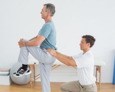 therapist-massaging-mans-lower-back-gym-hospital (1)
